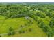 Breathtaking aerial view displaying the property's vast green spaces, mature trees, and the house at 3564 Clear Creek Blvd, Martinsville, IN 46151