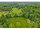 Impressive aerial view of the home surrounded by lush greenery, mature trees, and a well-maintained landscape at 3564 Clear Creek Blvd, Martinsville, IN 46151