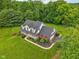 Aerial perspective of a brick home with mature trees and a well-maintained lawn at 3564 Clear Creek Blvd, Martinsville, IN 46151