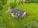 Expansive aerial view of the home with an outdoor patio, lush green lawn, and beautiful landscaping at 3564 Clear Creek Blvd, Martinsville, IN 46151