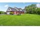 Spacious backyard with patio area, picnic table, and mature trees at 3564 Clear Creek Blvd, Martinsville, IN 46151
