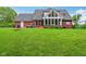 Expansive backyard featuring a lush lawn and a brick home exterior with a sunroom addition at 3564 Clear Creek Blvd, Martinsville, IN 46151