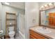 Practical bathroom featuring a shower-tub combo, open wood shelving and a framed mirror at 3564 Clear Creek Blvd, Martinsville, IN 46151