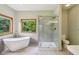 Modern bathroom with standalone tub, glass shower, and bright window at 3564 Clear Creek Blvd, Martinsville, IN 46151