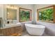Bright bathroom features a standalone tub, modern vanity, and two windows at 3564 Clear Creek Blvd, Martinsville, IN 46151