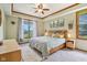 Bedroom featuring tray ceilings, a ceiling fan, and a large picture window at 3564 Clear Creek Blvd, Martinsville, IN 46151