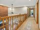 Second story hallway features wood railings and a brick accent wall at 3564 Clear Creek Blvd, Martinsville, IN 46151