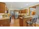 Spacious kitchen boasting wood cabinets, granite counters, and stainless steel refrigerator at 3564 Clear Creek Blvd, Martinsville, IN 46151