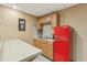 This kitchenette includes ample cabinets, countertop space, and a retro-style red refrigerator at 3564 Clear Creek Blvd, Martinsville, IN 46151