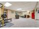 Large, carpeted living room with comfortable seating, a kitchenette, and space for workout equipment at 3564 Clear Creek Blvd, Martinsville, IN 46151