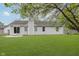 Home's backyard featuring a patio, sliding glass doors, and lush lawn at 374 Pomona Ct, Greenfield, IN 46140