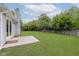 Well-maintained backyard with a patio, grassy lawn, and mature trees at 374 Pomona Ct, Greenfield, IN 46140