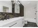 Modern bathroom featuring dual sinks, tub, and decorative wallpaper at 374 Pomona Ct, Greenfield, IN 46140