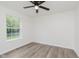 Bright bedroom with a ceiling fan, new vinyl floors, and a large window with outdoor view at 374 Pomona Ct, Greenfield, IN 46140