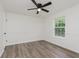 Bedroom features updated vinyl floors, a ceiling fan, and a window with natural light at 374 Pomona Ct, Greenfield, IN 46140