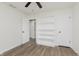 Spacious bedroom featuring vinyl floors, a fan, and a large shelving unit for storage at 374 Pomona Ct, Greenfield, IN 46140