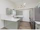 Stylish kitchen with stainless steel fridge, gray cabinets, and modern light fixtures at 374 Pomona Ct, Greenfield, IN 46140