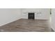 Neutral living room features wood-look floors, recessed lighting, and a modern fireplace at 374 Pomona Ct, Greenfield, IN 46140