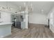 Open-concept living area with fireplace, gray cabinets, and modern lighting at 374 Pomona Ct, Greenfield, IN 46140