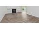 Bright living room featuring wood-look flooring, neutral walls, and a fireplace at 374 Pomona Ct, Greenfield, IN 46140