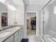 This bathroom features double sinks, a glass enclosed shower and access to a walk-in closet at 395 Ehrlich Ln, Westfield, IN 46074