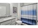 Bathroom featuring a single vanity with chrome faucet and shower/tub combination at 395 Ehrlich Ln, Westfield, IN 46074