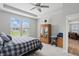 This bedroom features a large window, neutral colors, tray ceiling, and an armoire at 395 Ehrlich Ln, Westfield, IN 46074