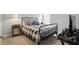 Bedroom with a modern iron frame bed, neutral colors, and an interesting bedside table at 395 Ehrlich Ln, Westfield, IN 46074