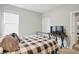 Bedroom features a metal bed frame, window, and an interesting display on a table at 395 Ehrlich Ln, Westfield, IN 46074