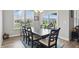 Dining room with large windows, contemporary lighting, and a dark wood table set with 6 chairs at 395 Ehrlich Ln, Westfield, IN 46074