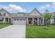 Charming home showcasing a well-manicured lawn, a two-car garage, and a cozy front porch with elegant columns at 395 Ehrlich Ln, Westfield, IN 46074