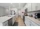 Bright eat-in kitchen with stainless appliances, stone countertops, and an island with stainless dishwasher at 395 Ehrlich Ln, Westfield, IN 46074