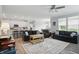 Open-concept living space with hardwood floors, neutral tones, and seamless flow to the kitchen and dining areas at 395 Ehrlich Ln, Westfield, IN 46074