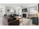 The spacious living room is filled with natural light and features a fireplace, ceiling fan, and hardwood flooring at 395 Ehrlich Ln, Westfield, IN 46074