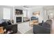 Bright living room with a fireplace, hardwood floors, and large windows that let in plenty of natural light at 395 Ehrlich Ln, Westfield, IN 46074