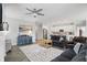 Spacious living area with hardwood floors, a fireplace, and seamless access to the modern kitchen at 395 Ehrlich Ln, Westfield, IN 46074