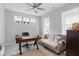 Well-lit home office featuring a large desk, couch, and ample natural light from multiple windows at 395 Ehrlich Ln, Westfield, IN 46074