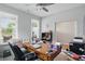 Well-lit home office features a large desk, couch, and ample natural light from multiple windows at 395 Ehrlich Ln, Westfield, IN 46074