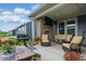 Relaxing covered patio with a brick fireplace and comfortable seating at 395 Ehrlich Ln, Westfield, IN 46074