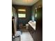 This cozy bathroom features a sink vanity, toilet, and shower/tub combination with a window for natural light at 409 W 3Rd St, Alexandria, IN 46001