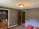 This bedroom offers closet space and is freshly painted with wood-look laminate flooring and a modern light fixture at 409 W 3Rd St, Alexandria, IN 46001