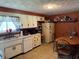 Functional kitchen featuring white appliances, ample cabinet space, and a cozy breakfast nook area for casual dining at 409 W 3Rd St, Alexandria, IN 46001