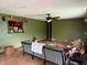 Spacious living room with wood-look flooring, ceiling fan, and a large window providing ample natural light at 409 W 3Rd St, Alexandria, IN 46001