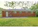 Brick exterior with a well-maintained backyard and lush green grass, creating a serene outdoor space at 412 S Norfolk St, Indianapolis, IN 46241