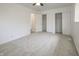 A bright bedroom with two closets, neutral carpet, and white walls at 412 S Norfolk St, Indianapolis, IN 46241