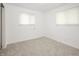 Bright bedroom featuring neutral carpet and two windows with blinds, perfect for natural light at 412 S Norfolk St, Indianapolis, IN 46241