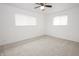 A sunny bedroom features carpet, two windows, and standard ceiling fan at 412 S Norfolk St, Indianapolis, IN 46241