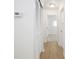 Hallway featuring wood floors, access to other rooms, and thermostat on the wall at 412 S Norfolk St, Indianapolis, IN 46241