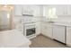 Bright kitchen features white cabinetry, modern appliances, and a stainless steel sink overlooking the backyard at 412 S Norfolk St, Indianapolis, IN 46241