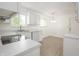 Bright white kitchen equipped with stainless steel sink and views of the dining area at 412 S Norfolk St, Indianapolis, IN 46241